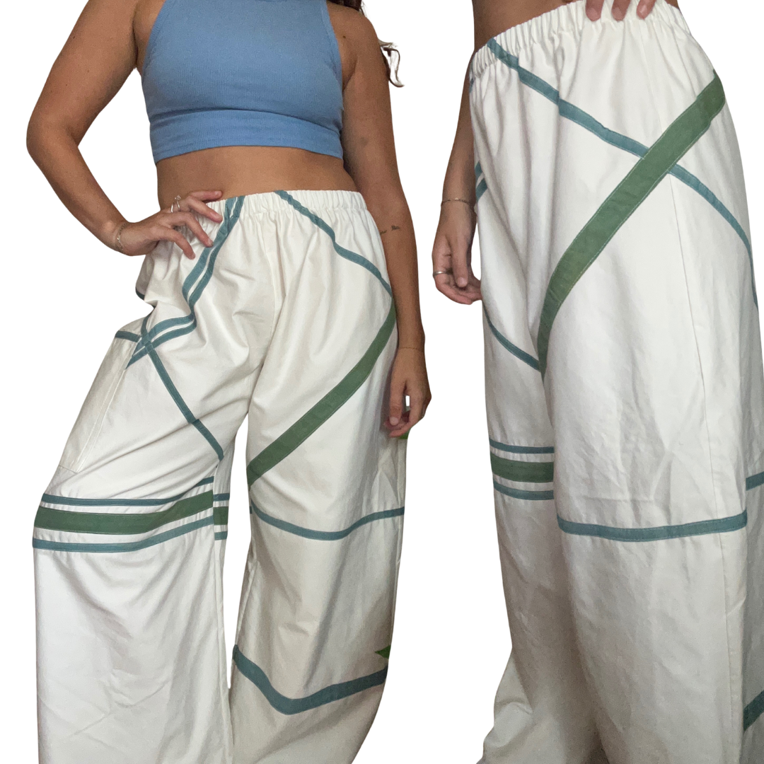 White pants with green and blue accents worn by a person on a white background.
Plant dyed with indigo and marigold.