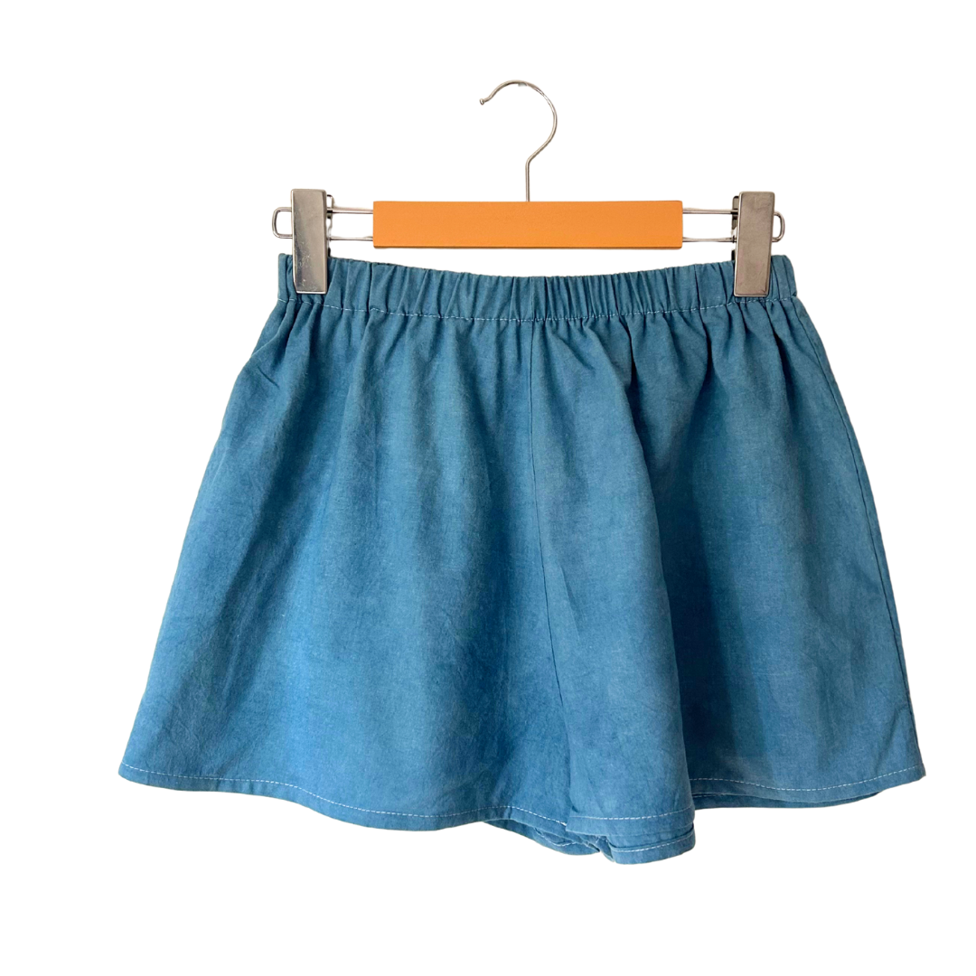 Blue boxer shorts on a hanger.
Naturally dyed with indigo.